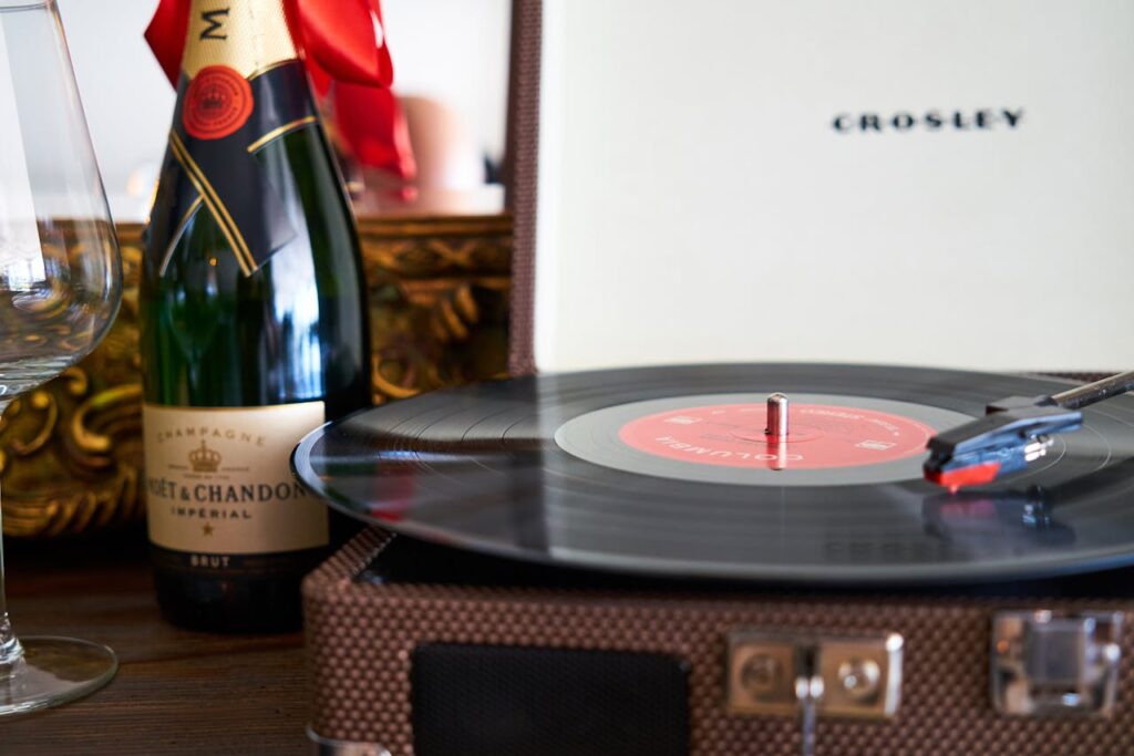 Soothing music playing on a CD player, with a wine bottle nearby, creating a luxurious Valentine's Day party atmosphere.