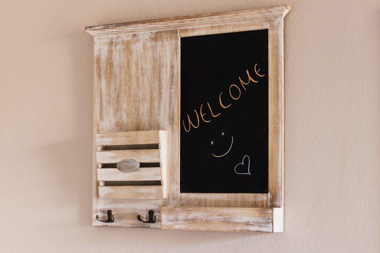 Board on the wall with a warm welcome note for guests, featuring greeting cards for Valentine's Day.