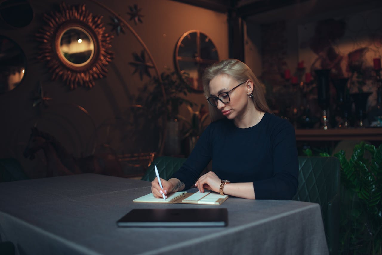 Host writing notes for her guests, incorporating greeting cards for Valentine's Day for a personalized touch.