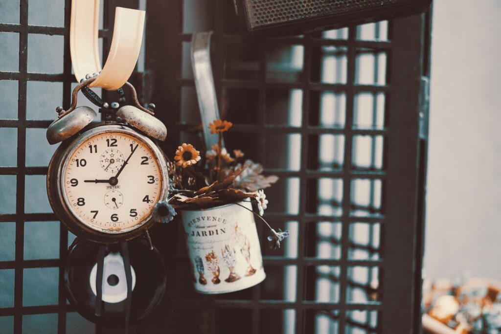 Old table clock used as vintage decor, hanging as an elegant decor piece, adding a timeless charm to any room.