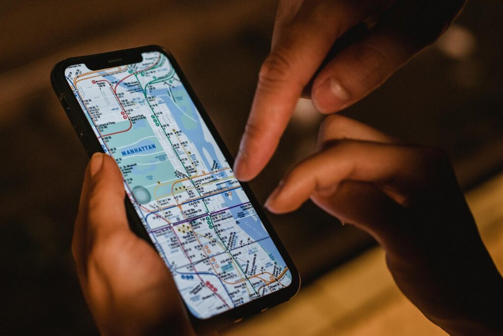 People using a travel app on their mobile phones to check directions, one of best travel apps