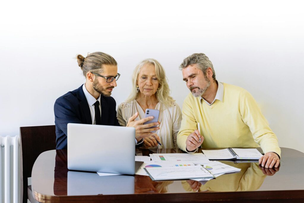 A travel insurance agent explaining various insurance plans to clients in an office setting.