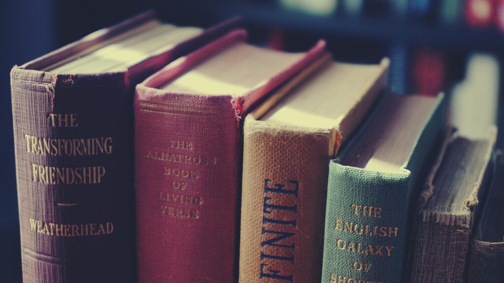 Old books used as decor items, stacked and arranged creatively to add a vintage touch to the space.