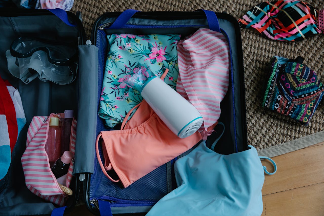 A travel bag packed with swim gear, towels, and other beach essentials, ready for a seaside adventure.