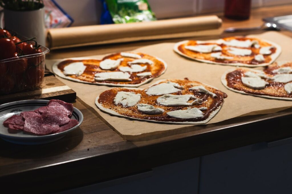 Heart-shaped pizzas being prepared for baking, ready to be served as a romantic treat for Valentine's Day.