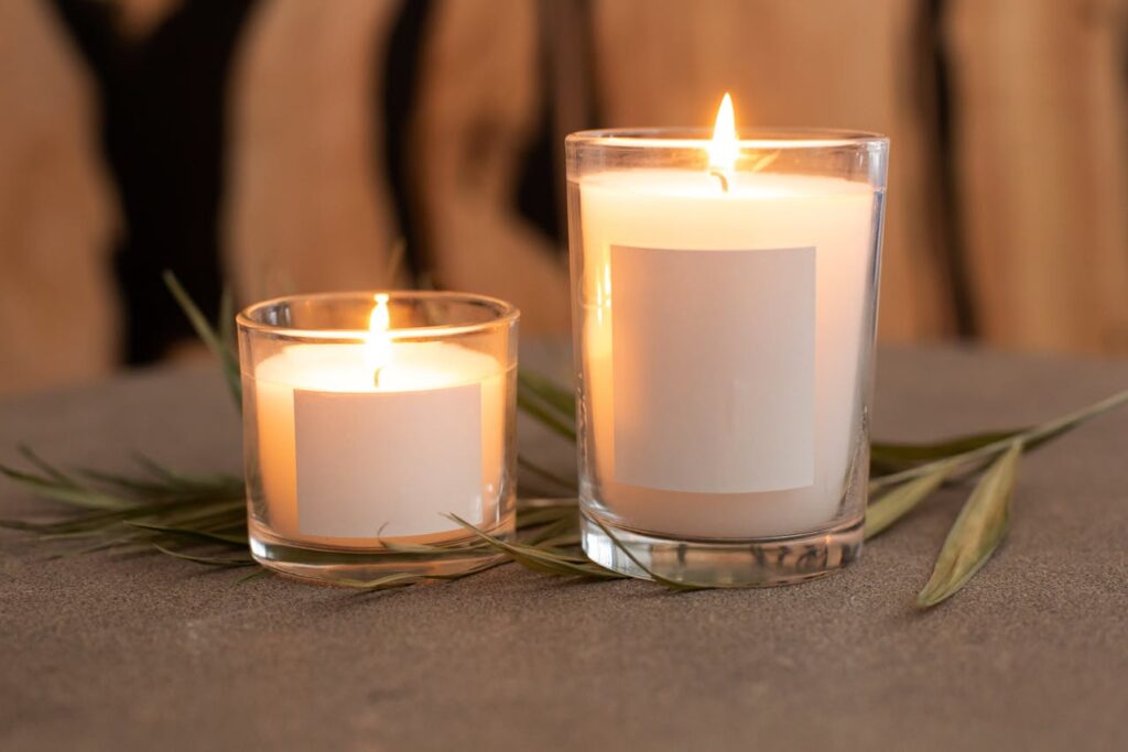 Beautiful scented candles placed on soft fabric with a leaf, creating a warm and romantic ambiance—perfect as custom Valentine’s Day gifts for Valentine’s Day 2025.