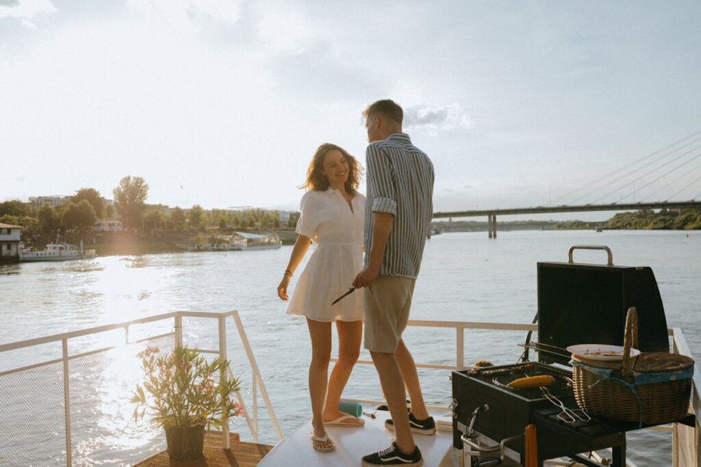 A couple cooking food and interacting with each other while sailing on a boat along the river, embracing adventure travel ideas for Valentine's Day