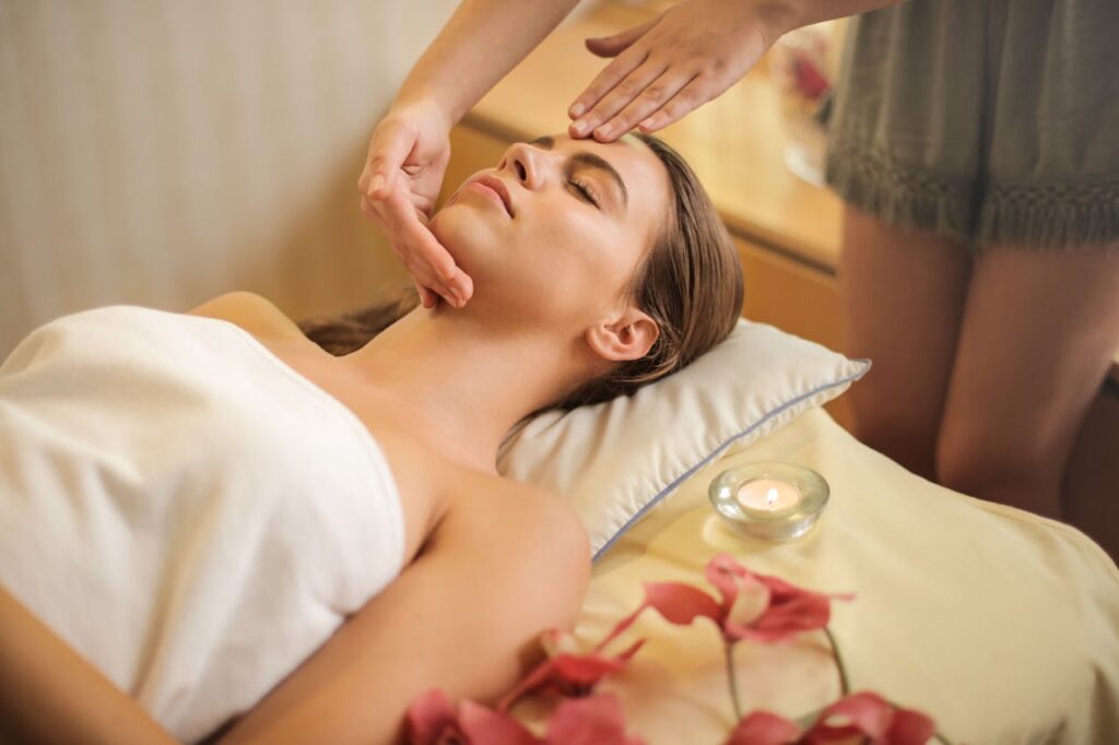 A woman enjoying a relaxing massage in a peaceful, candlelit spa setting with flowers, perfect for a romantic spa retreat on Valentine's Day 2025.