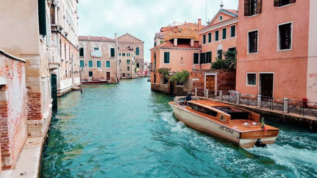 A breathtaking romantic view of Venice, Italy, showcasing the shimmering waters of the Grand Canal, historic buildings, and the charm of a dreamy Valentine’s Day escape.