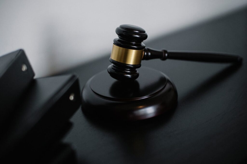 Law hammer on a table symbolizing legal requirements and regulations for how to start an Airbnb business.