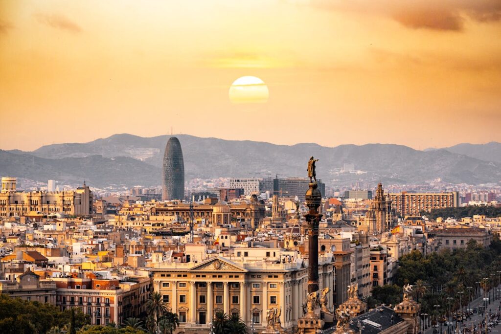 A panoramic city view of Barcelona showcasing iconic landmarks like Sagrada Família and the Mediterranean coastline, perfect for any Spain travel itinerary.