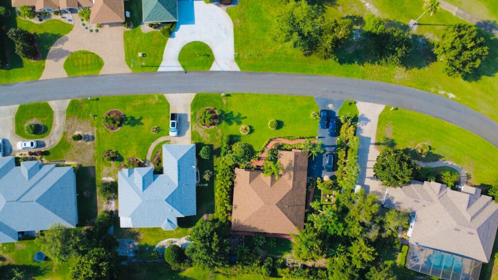 Aerial view of houses with beautiful surroundings and road connectivity, ideal for Airbnb arbitrage.