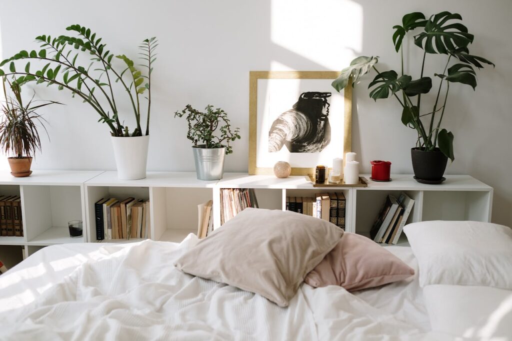 Relaxing room with artificial plants for home decor, books on the table, and comfortable seating with cushions.