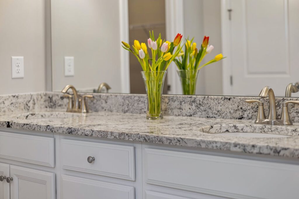 Colorful tulips in a vase placed in a bathroom for refreshing flower decoration at home.