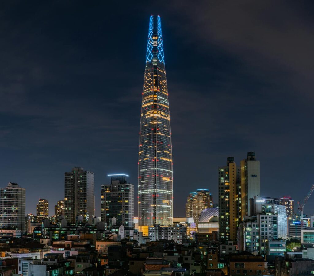 Bird’s eye view of lighted buildings in Seoul at night, featured in a Seoul travel itinerary.