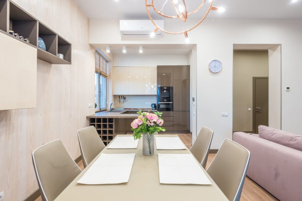Modern studio apartment dining area with elegant flower decoration at home.