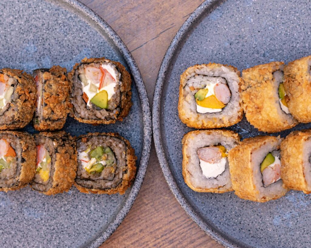 Crispy sushi rolls served on ceramic plates in a traditional Japanese restaurant, a delicious highlight of any Japan travel itinerary.