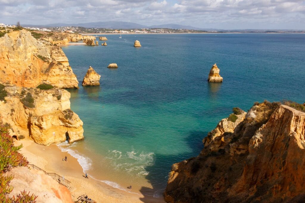 Aerial view of Praia do Camilo on the Algarve coastline, a stunning beach destination featured in a Portugal travel itinerary.