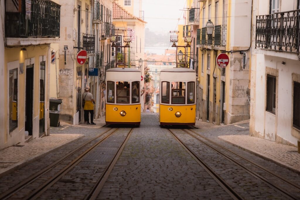 Vintage yellow trams navigating the historic streets of Lisbon, a cultural highlight in any Portugal travel itinerary.