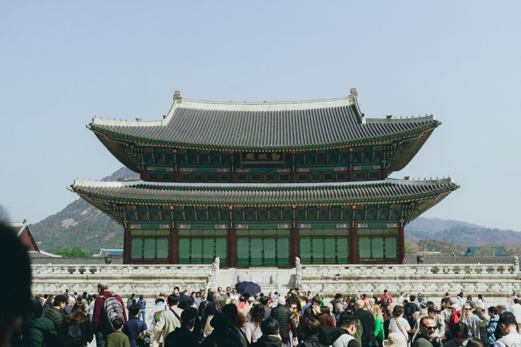 Tourists visiting Gyeongbokgung Palace, a historical highlight in a Seoul travel itinerary.