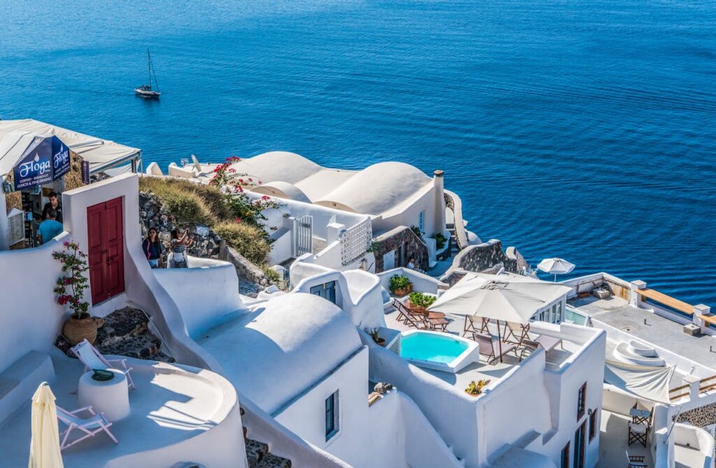 White buildings overlooking the Aegean Sea in Santorini, a breathtaking stop on any Greece travel itinerary.