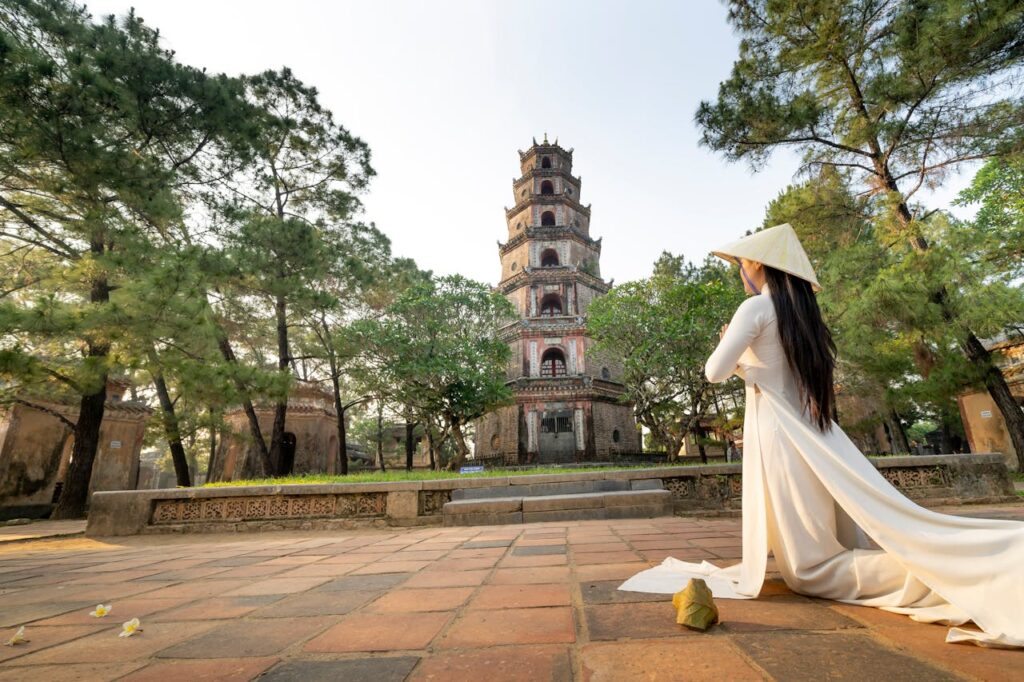 A woman tourist offering prayers at a traditional religious site in Vietnam during her Vietnam travel itinerary.