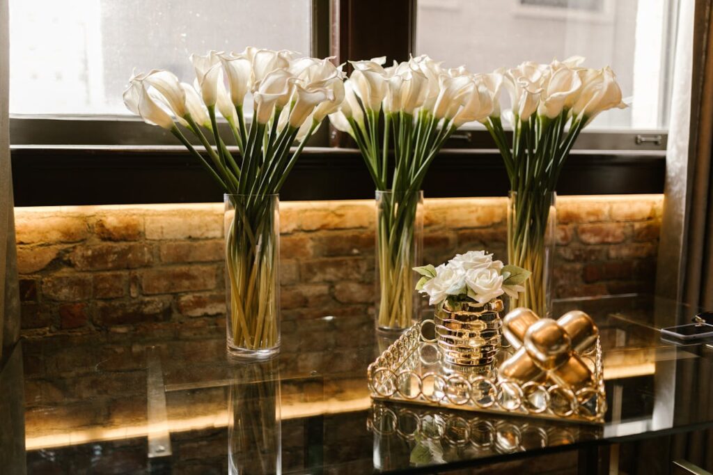 White flowers placed in the corner of a living room as part of elegant flower decoration at home.