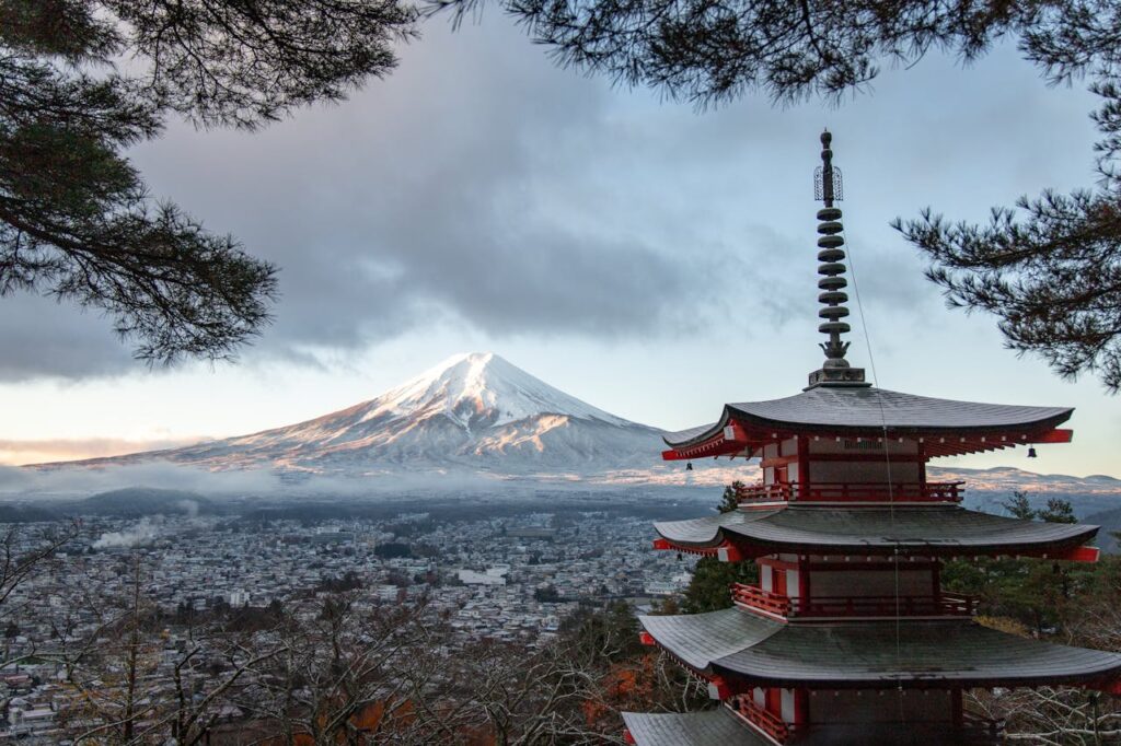 Snow-covered Mount Fuji in winter, viewed from a distance with clear skies, perfect for a Japan travel itinerary.