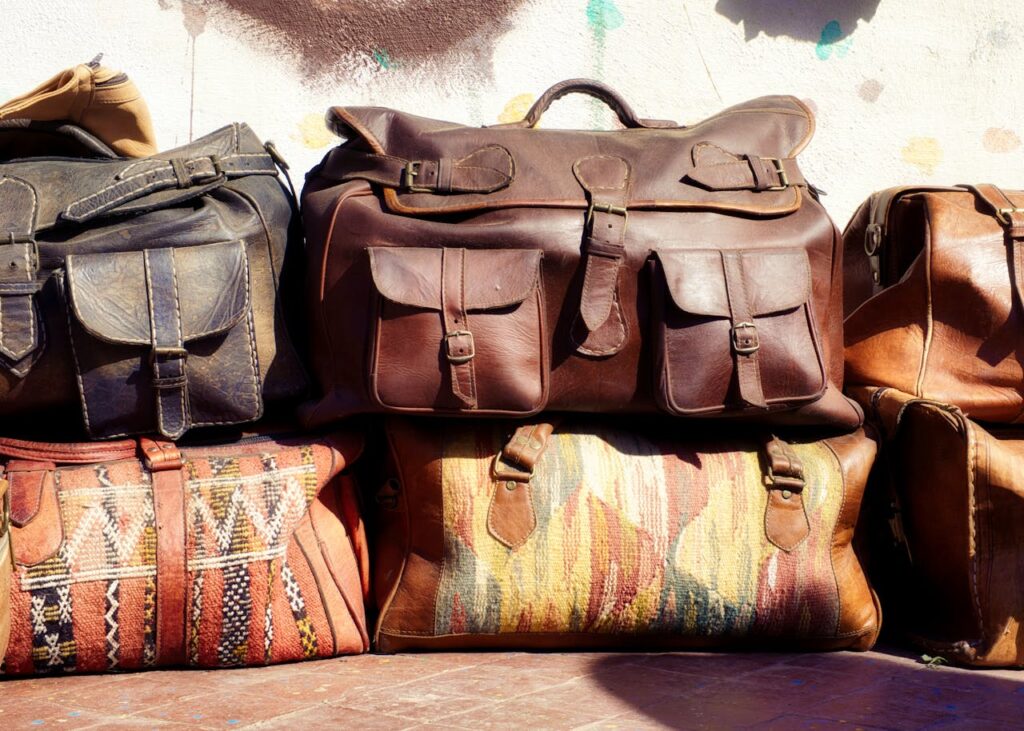 Handcrafted leather bags and textiles in a Moroccan market in Fes – Morocco travel itinerary