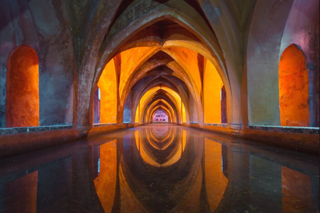 Vibrant orange and gray tunnel painting in Seville, a hidden artistic gem to discover on your Spain travel itinerary.