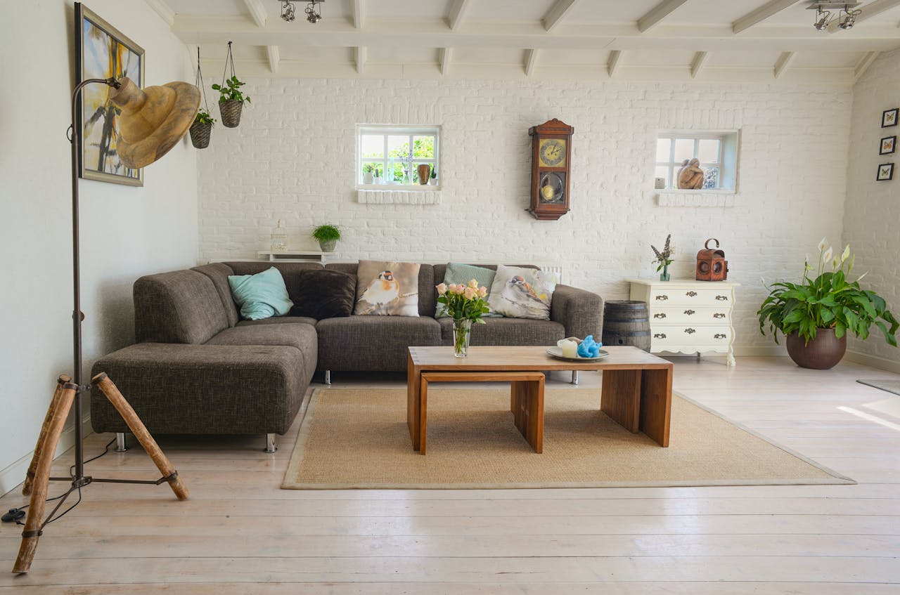 Beautiful living room with white walls, couch, and natural light, ideal to get featured on Airbnb