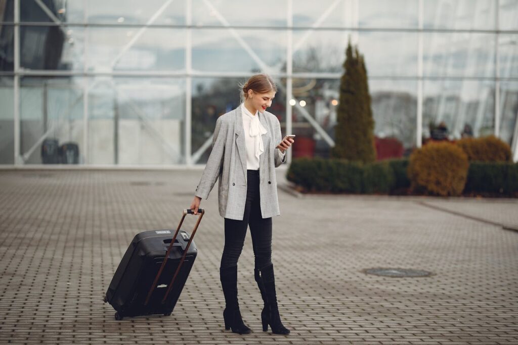 Entrepreneur booking flight on Amex travel app, showcasing Amex GBT competitors in corporate travel technology