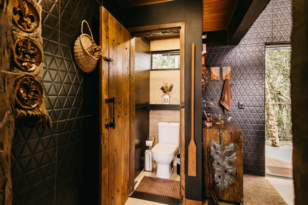 Elegant washroom with black tiles and jute decor accents, styled to get featured on Airbnb