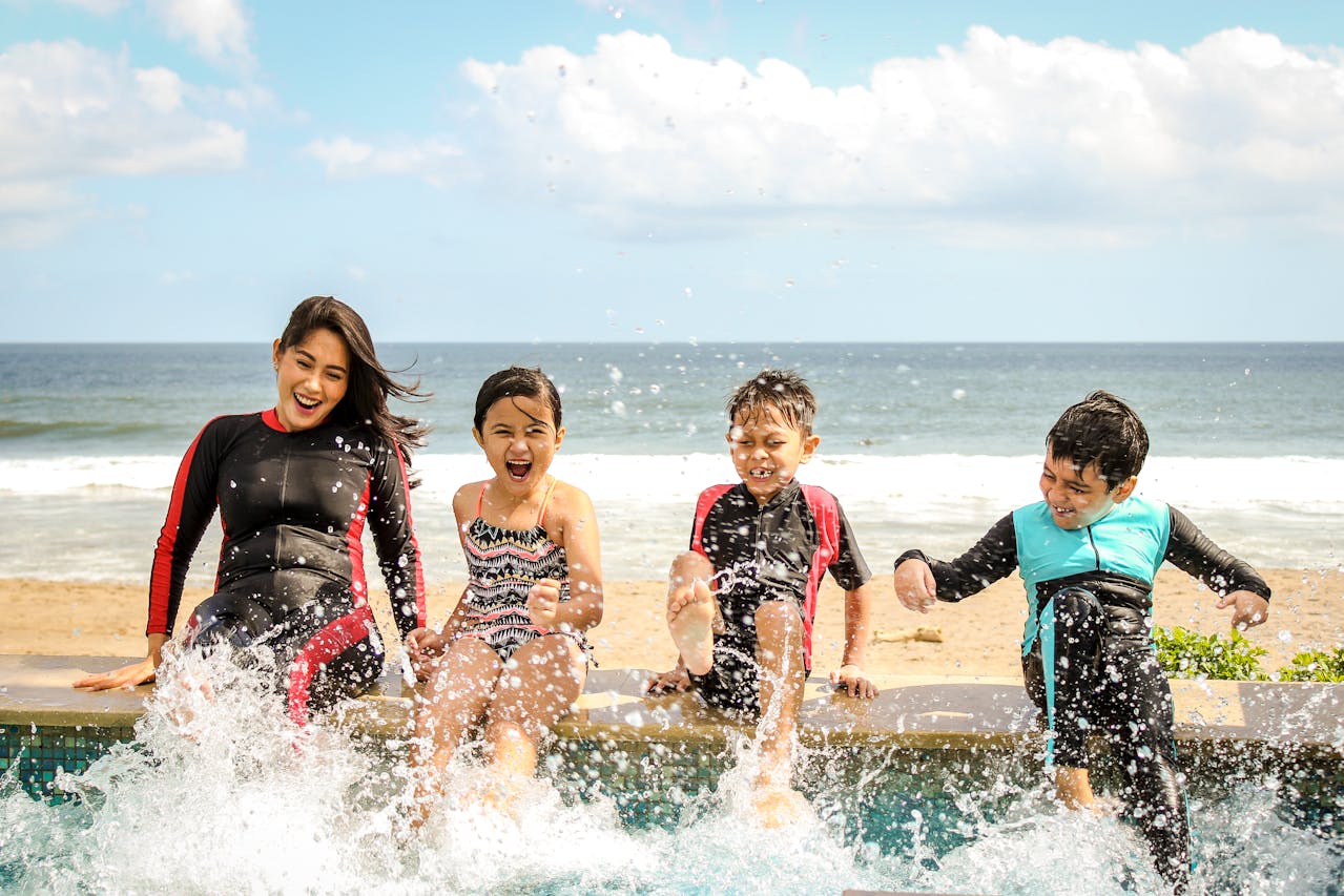 Family enjoying a swimming pool at a vacation rental with safe water practices to reduce risks of brain eating amoeba.